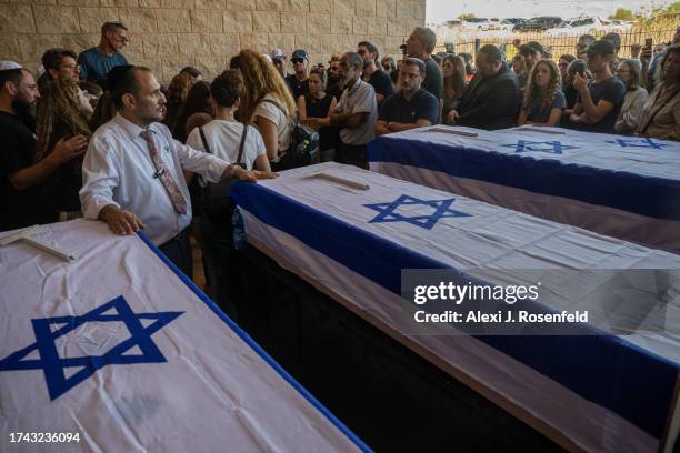 Family and friends grieve for Yitzhak Seitan his wife, Hannah Seitan their son, Tal Seitan and his aunt Pesi Cohen during the funeral at the Hod...