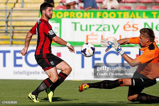 Shane Long of West Bromwich Albion challenges the goalkeeper of Puskas FC Academy during the pre season friendly match between Puskas FC Academy and...