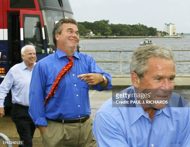 President George W. Bush, followed by his brother and Florida Governor Jeb Bush, US Senator and former election campaign rival John McCain walk off...