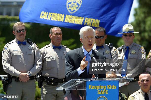 California Gov. Gray Davis, with California Highway Patrol officers listening, speaks at an event to mark the first year anniversary of the Amber...
