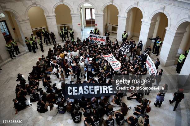 Demonstrators hold a rally demanding a cease fire in Gaza in the rotunda of the Cannon House Office Building on October 18, 2023 in Washington, DC....