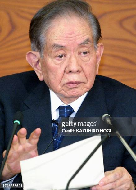 Masaru Hayami, incumbent Bank of Japan governor, gestures as he answers a question during his last regular news conference at the central bank's...