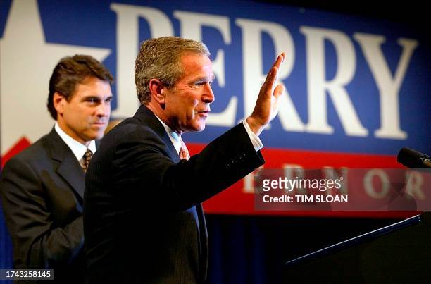 President George W. Bush takes the stage to address a Republican fund raiser for Texas Governor Rick Perry at the Hyatt Hotel 14 June 2002 in...