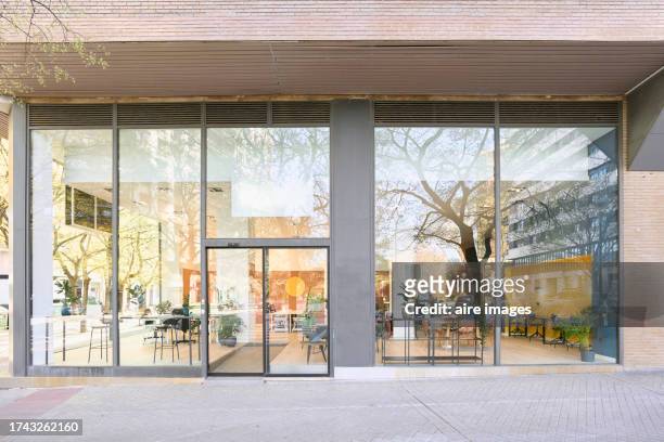 front view of the exterior entrance of an office building with glass door and walls. - stained glass door stock pictures, royalty-free photos & images