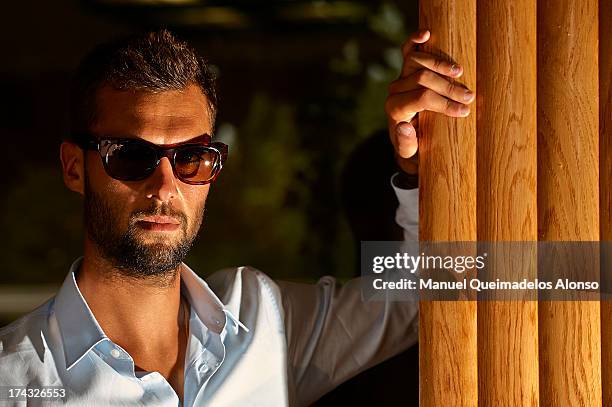 Professional tennis player Benoit Paire poses during a Maui Jim shooting at Lagardere Racing Club on July 23, 2013 in Paris, France.