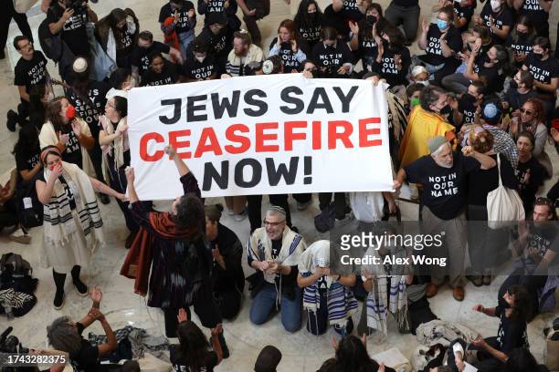 Protesters hold a demonstration in support of a cease fire in Gaza in the Cannon House Office Building on October 18, 2023 in Washington, DC. Members...
