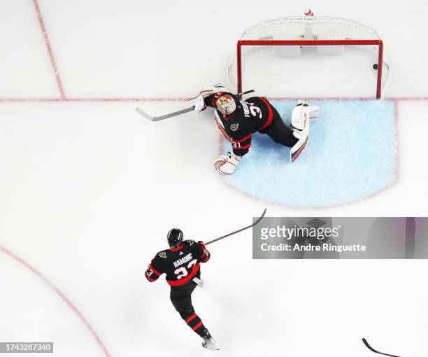 The puck hits the back of the net behind Anton Forsberg of the Ottawa Senators after Jeff Skinner of the Buffalo Sabres scores a goal as Travis...