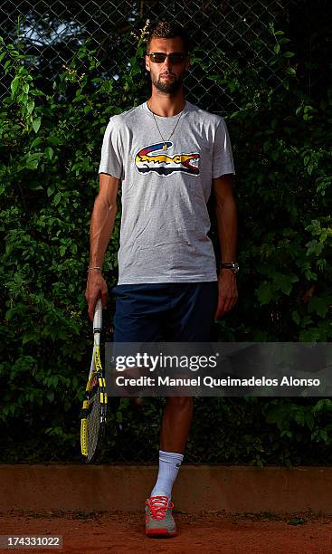 Professional tennis player Benoit Paire poses during a Maui Jim shoot at Lagardere Racing Club on July 23, 2013 in Paris, France.