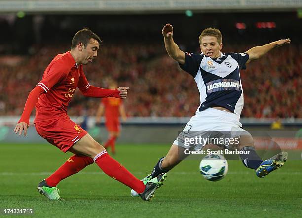 Iago Aspas of Liverpool takes a shot at goal as Adrian Leijer of the Victory defends during the match between the Melbourne Victory and Liverpool at...