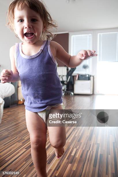 playful baby girl - baby run stock pictures, royalty-free photos & images