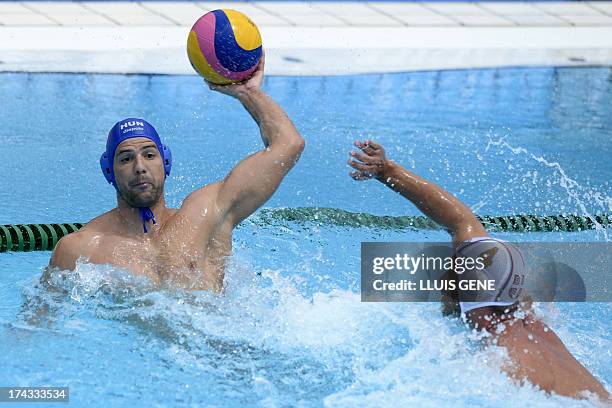 Hungary's Norbet Madaras vies with Serbia's Vanja Udovicic during the preliminary round match of the men's water polo competition between Serbia and...