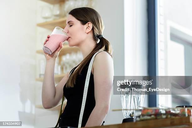 woman drinking a meal replacement shakes - milkshake stock pictures, royalty-free photos & images