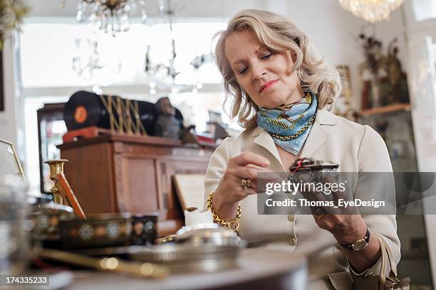 senior woman in antique shop - antique stock pictures, royalty-free photos & images
