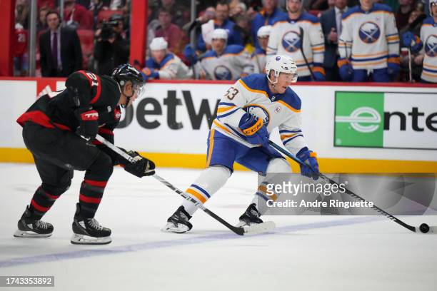 Jeff Skinner of the Buffalo Sabres controls the puck against Mathieu Joseph of the Ottawa Senators at Canadian Tire Centre on October 24, 2023 in...