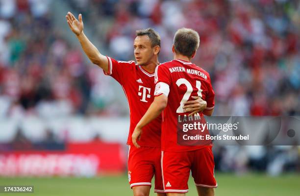 Rafinha and Philipp Lahm of FC Bayern Muenchen gesture during the Telekom 2013 Cup final between FC Bayern Muenchen and Borussia Moenchengladbach at...