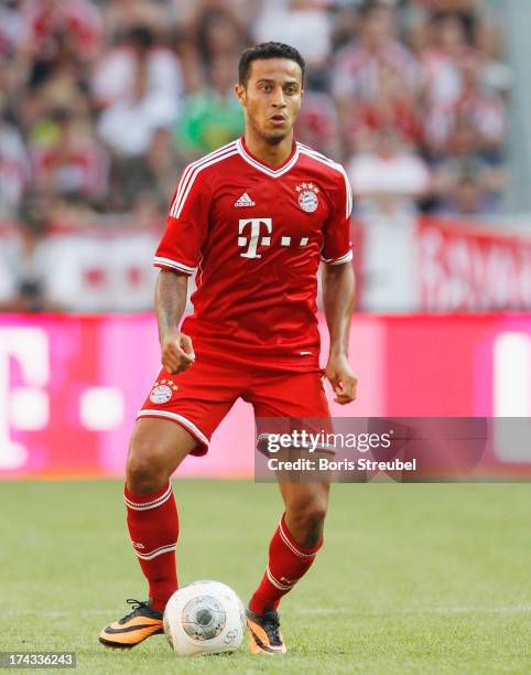 Thiago of FC Bayern Muenchen runs with the ball during the Telekom 2013 Cup final between FC Bayern Muenchen and Borussia Moenchengladbach at...