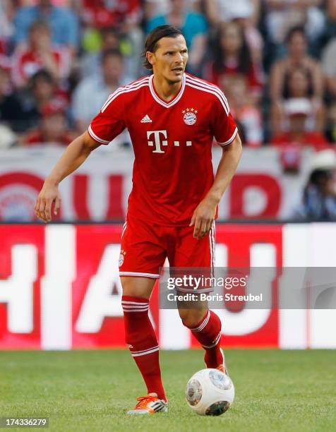 Daniel van Buyten of FC Bayern Muenchen runs with the ball during the Telekom 2013 Cup final between FC Bayern Muenchen and Borussia Moenchengladbach...