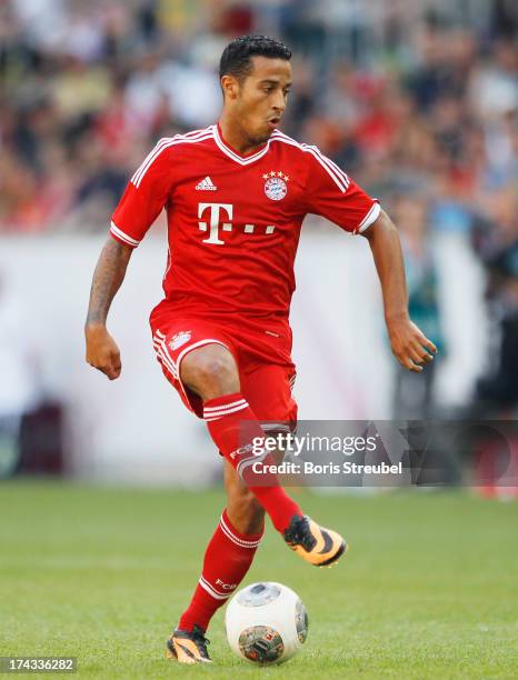 Thiago of FC Bayern Muenchen runs with the ball during the Telekom 2013 Cup final between FC Bayern Muenchen and Borussia Moenchengladbach at...