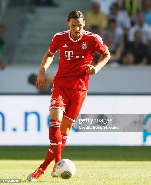 Daniel van Buyten of FC Bayern Muenchen runs with the ball during the Telekom 2013 Cup final between FC Bayern Muenchen and Borussia Moenchengladbach...