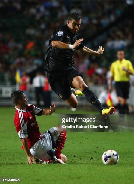 Aleksandar Kolarov of Mancester City leaps over his opponent during the Barclays Asia Trophy Semi Final match between Manchester City and South China...