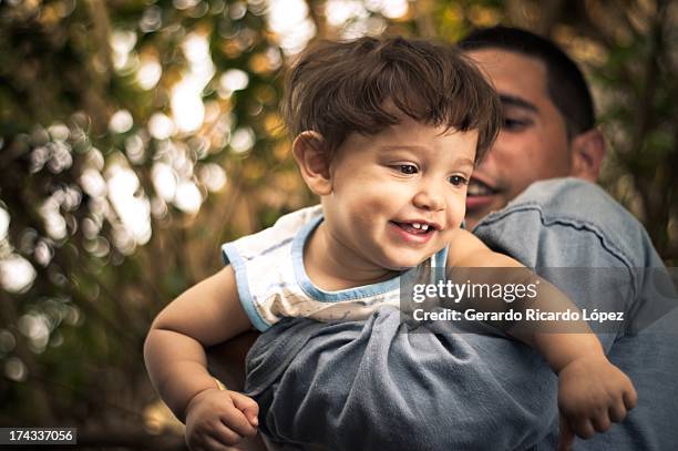 father and son playing together. - holguin stock-fotos und bilder