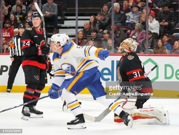Anton Forsberg and Jacob Bernard-Docker of the Ottawa Senators looks on after Alex Tuch of the Buffalo Sabres scores a goal against him during the...