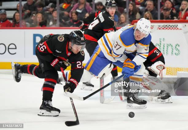 Erik Brannstrom of the Ottawa Senators battles for puck possession against Casey Mittelstadt of the Buffalo Sabres at Canadian Tire Centre on October...