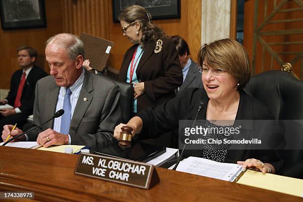 Joint Economic Committee Vice Chair Sen. Amy Klobuchar gavels into session a hearing about on fixing America's crumbling infrastructure with Sen. Dan...