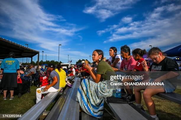 Indigenous peoples of the Americas watch others dance and perform rituals as they attend a cultural meeting at the Comanche Nation fairgrounds in...