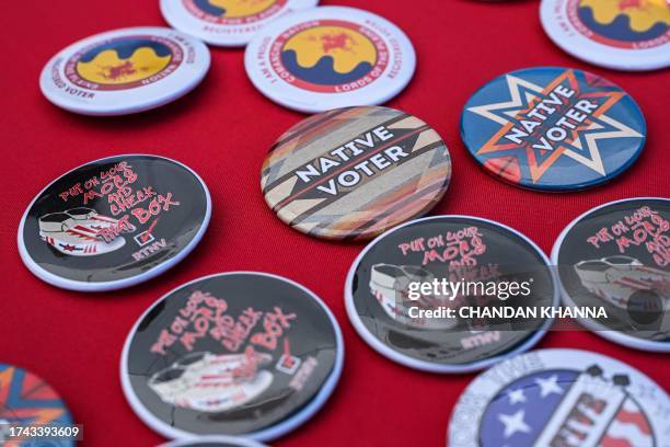 Pins are pictures are pictured at a display counter during a cultural meeting at the Comanche Nation fairgrounds in Lawton, Oklahoma on September 30,...