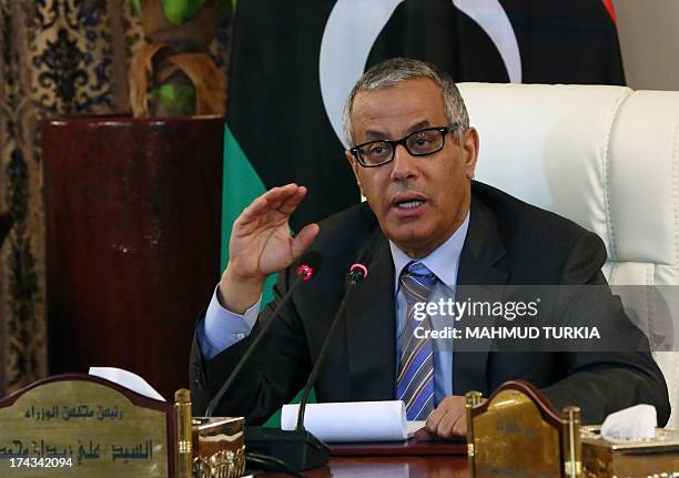 Libyan Prime Minister Ali Zaidan speaks during a press conference with Interior Minister following a rocket attack on a building located in a...