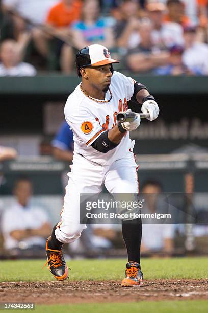 Alexi Casilla of the Baltimore Orioles bunts against the Texas Rangers on July 8, 2013 at Oriole Park at Camden Yards in Baltimore, Maryland. The...