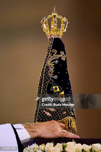 Pope Francis touches the statue of Our Lady of the Immaculate Conception as he celebrates Mass at the Basilica of the National Shrine of Our Lady...