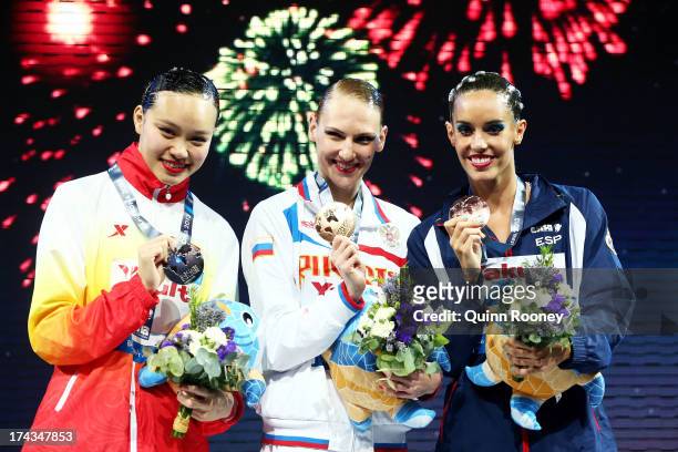 Silver medallist Huang Xuechen of China, gold medallist Svetlana Romashina of Russia and bronze medallist Carbonell Ballestero of Spain celebrate...