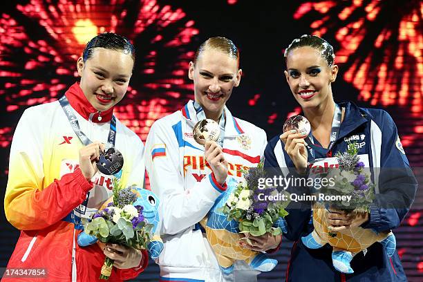 Silver medallist Huang Xuechen of China, gold medallist Svetlana Romashina of Russia and bronze medallist Carbonell Ballestero of Spain celebrate...