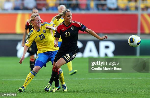 Marie Hammarstroem of Sweden and Lena Goessling of Germany battle for the ball during the UEFA Women's Euro 2013 semi final match between Sweden and...