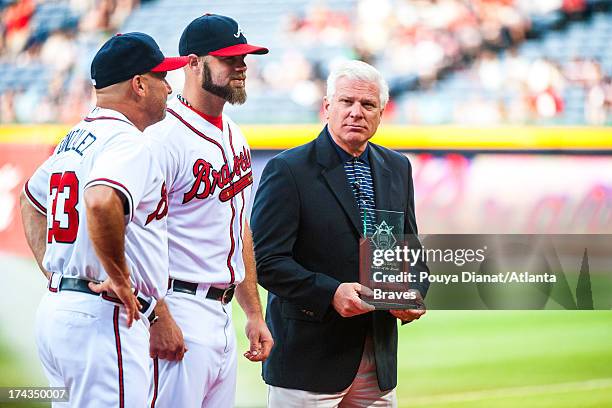 Atlanta Braves general manager Frank Wren and Fredi Gonzalez of the Atlanta Braves honor Evan Gattis of the Atlanta Braves during a pre game ceremony...