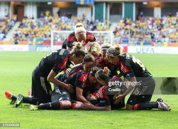 Germany's forward Dzsenifer Marozsan celebrates with her teammates after scoring past Sweden's goalkeeper Kristin Hammarstrom during the UEFA Women's...