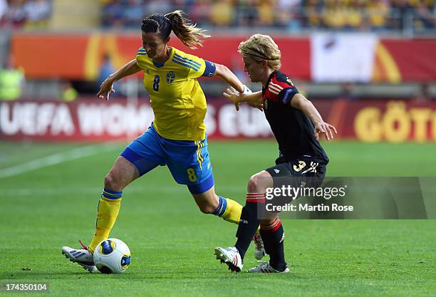 Lotta Schelin of Sweden and Saskia Bartusiak of Germany battle for the ball during the UEFA Women's Euro 2013 semi final match between Sweden and...