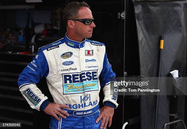Dave Blaney, driver of the Reese Towpower Ford, looks on during practice for the NASCAR Camping World Truck Series inaugural Mudsummer Classic at...
