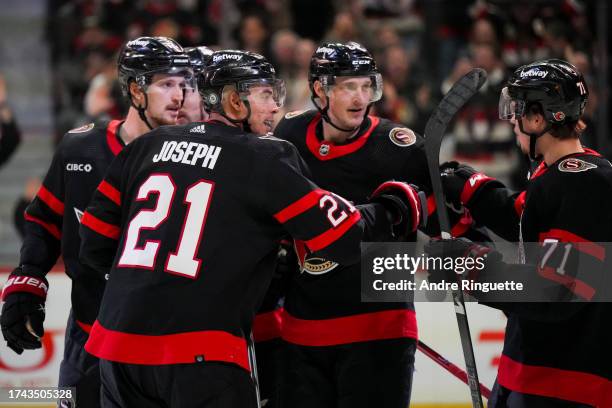 Mathieu Joseph of the Ottawa Senators celebrates his third period goal against the Buffalo Sabres with teammates Ridly Greig, Thomas Chabot and...