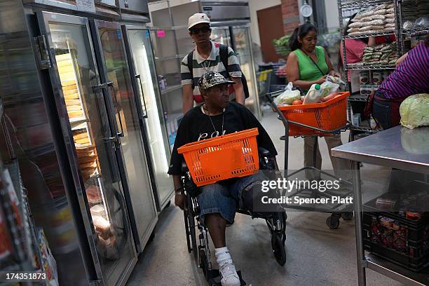 Kevin Wilson, a client of the West Side Campaign Against Hunger food bank, shops for food on July 24, 2013 in New York City. The food bank assists...