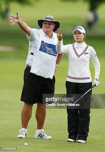 Hee Kyung Seo of South Korea and caddie Dean Herden plan a shot during the weather-delayed second round of the Wegmans LPGA Championship at Locust...