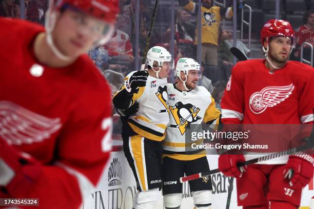Evgeni Malkin of the Pittsburgh Penguins celebrates his first period goal with Reilly Smith while playing the Detroit Red Wings at Little Caesars...