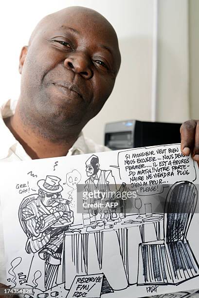 Congolese cartoonist for daily newspaper the Potentiel, Kashoun Thembo, also known as Kash, poses for a photograph on July 18, 2013 in Kinshasa. The...