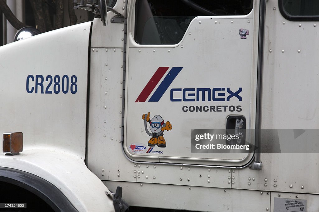 Cemex Script The logo for Cemex SAB is displayed on a truck at a construction site ...