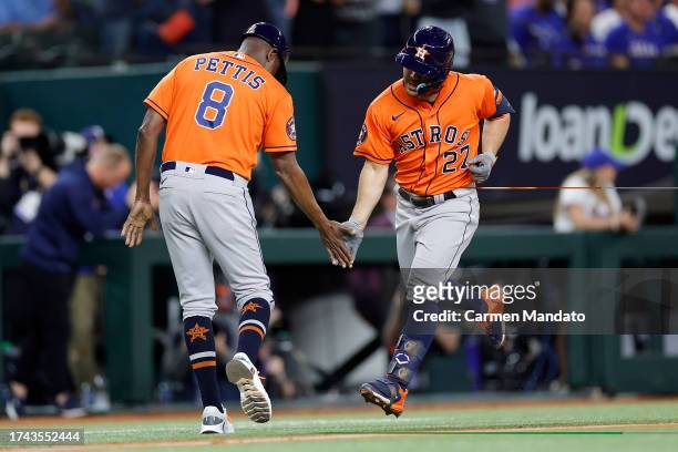 Jose Altuve of the Houston Astros celebrates as he rounds the bases after hitting a solo home run against Max Scherzer of the Texas Rangers during...