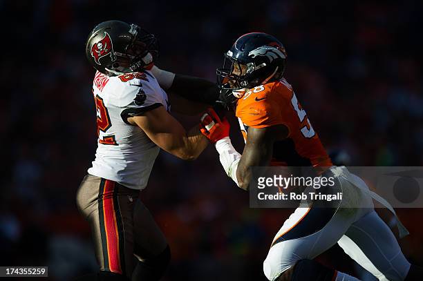 Von Miller of the Denver Broncos blocks Nate Byham of the Tampa Bay Buccaneers during the game at Sports Authority Stadium on December 2, 2012 in...
