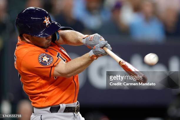 Jose Altuve of the Houston Astros hits a solo home run against Max Scherzer of the Texas Rangers during the third inning in Game Three of the...