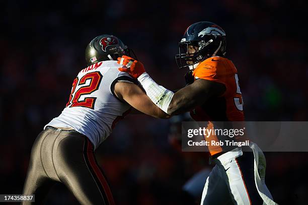 Von Miller of the Denver Broncos blocks Nate Byham of the Tampa Bay Buccaneers during the game at Sports Authority Stadium on December 2, 2012 in...